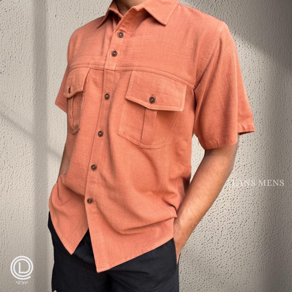 Man wearing a coral short-sleeve cargo shirt with black cargo pants