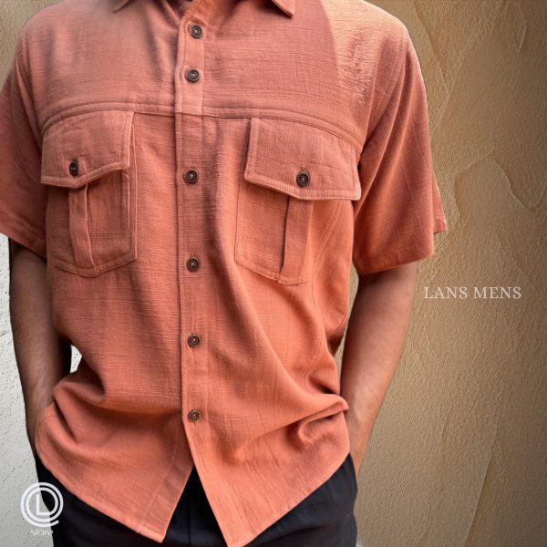 Man wearing a coral short-sleeve cargo shirt with black cargo pants