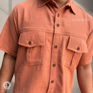 Man wearing a coral short-sleeve cargo shirt with black cargo pants