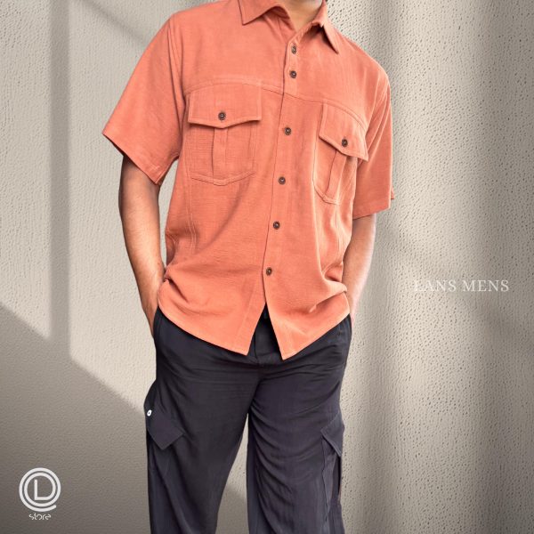 Man wearing a coral short-sleeve cargo shirt with black cargo pants