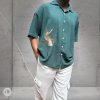 Oversized Green Cotton Shirt with embroidered songbird design