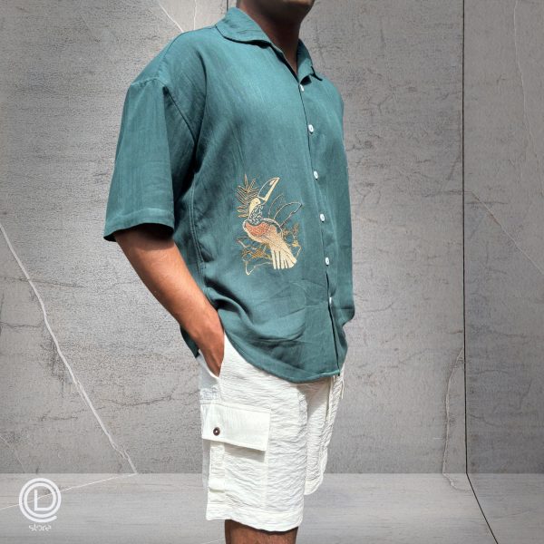 "Oversized Green Cotton Shirt with embroidered songbird and white cotton shorts