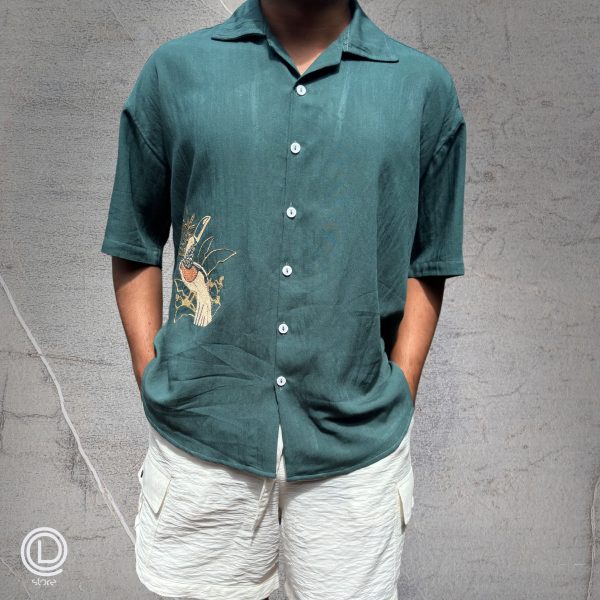 "Oversized Green Cotton Shirt with embroidered songbird and white cotton shorts