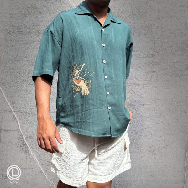 "Oversized Green Cotton Shirt with embroidered songbird and white cotton shorts