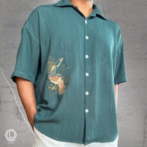 "Oversized Green Cotton Shirt with embroidered songbird and white cotton shorts