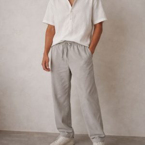 Oversized grey cotton pant with elasticated waistband and drawstring, worn by model in a relaxed fit