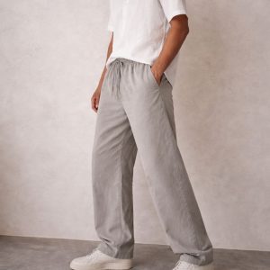 Oversized grey cotton pant with elasticated waistband and drawstring, worn by model in a relaxed fit