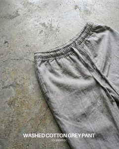 Oversized grey cotton pant with elasticated waistband and drawstring, worn by model in a relaxed fit