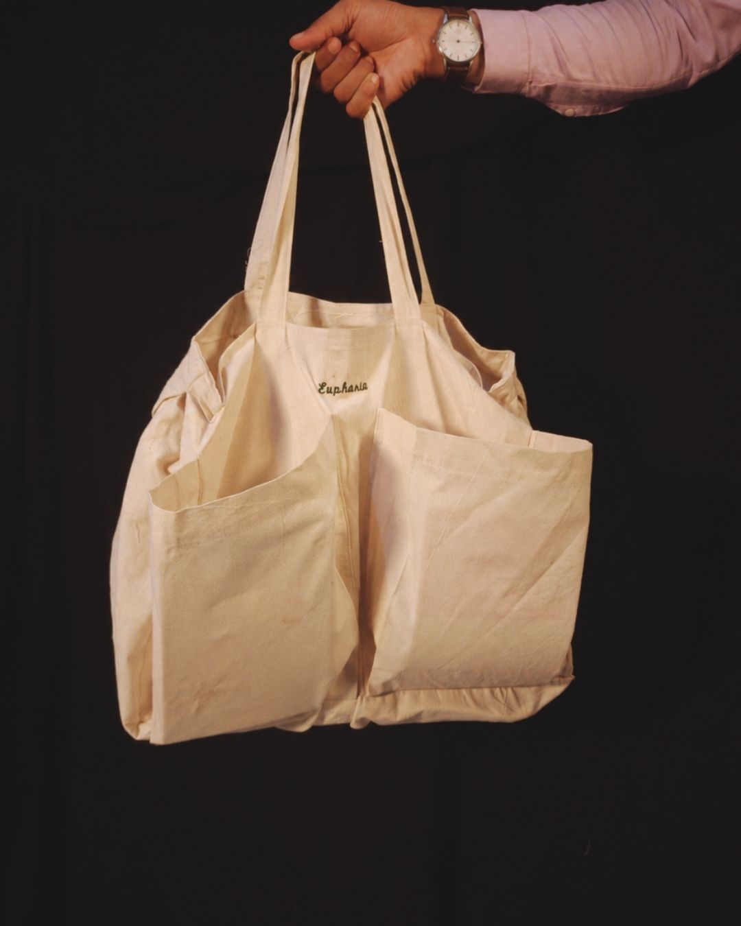 Lans Nomad Tote – Eutopia Embroidery Lans Nomad Tote in natural cotton canvas with Eutopia embroidery and large front pockets