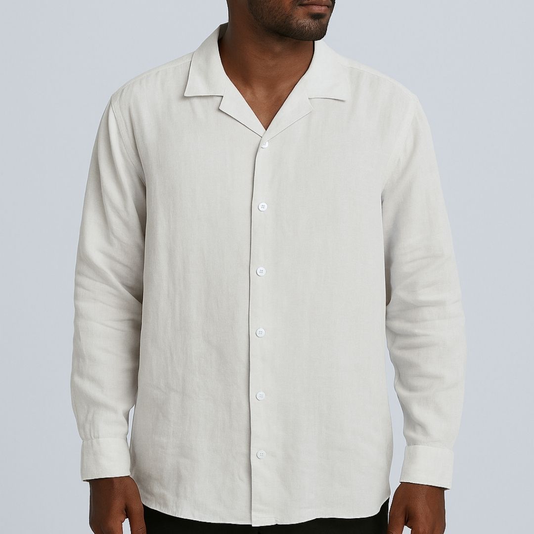 Relaxed Linen Shirt Collection – Black, Harvest Gold & Ivory | Lans Stack of three linen shirts in black, harvest gold, and ivory placed on a wooden stool — part of Lans’ Relaxed Cuban Collar Linen Collection