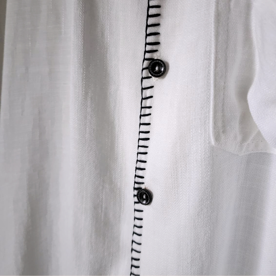 Man wearing oversized linen shirt art gallery style made in Sri Lanka (3) Crafted with soul in Sri Lanka. 🇱🇰 The Museo Heritage Shirt isn't just clothing; it's a feeling. Cut from pure linen in an oversized fit that lets the air—and the culture—flow freely. Available in sizes XS to 4XL.