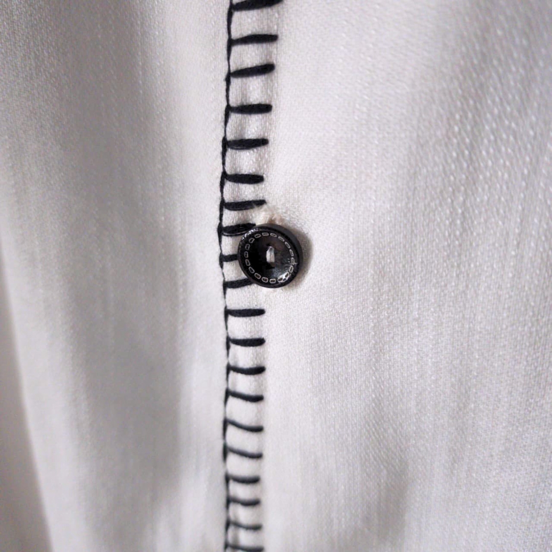 Man wearing oversized linen shirt art gallery style made in Sri Lanka (4) Crafted with soul in Sri Lanka. 🇱🇰 The Museo Heritage Shirt isn't just clothing; it's a feeling. Cut from pure linen in an oversized fit that lets the air—and the culture—flow freely. Available in sizes XS to 4XL.