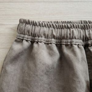 Close up of washed cotton fabric texture in greige grey beige tone