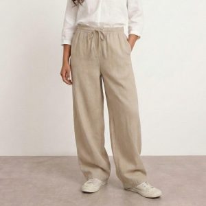 Close up of washed cotton fabric texture in greige grey beige tone