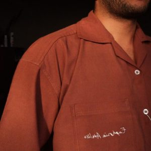 Close up of delicate Moroccan-inspired side embroidery on washed cotton shirt